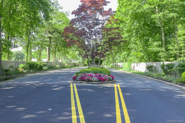a sign that is sitting in front of flowers