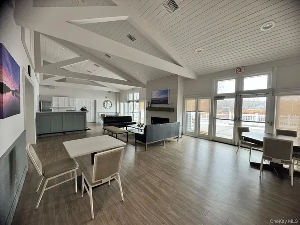 a room with stainless steel appliances furniture and a kitchen view