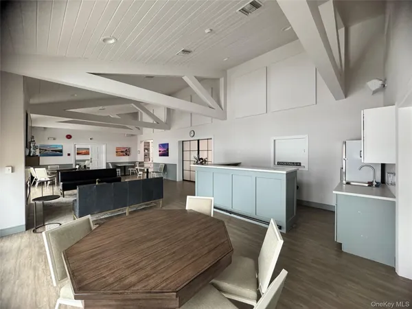 a living room with furniture a flat screen tv and a table