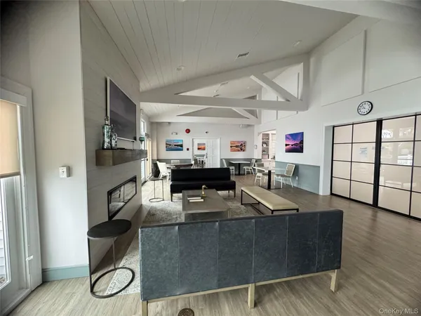 a living room with furniture a fireplace and a wooden floor