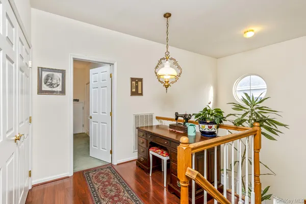 a view of an entryway with wooden floor