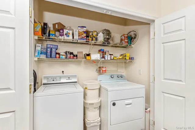 a view of storage and utility room with washer and dryer