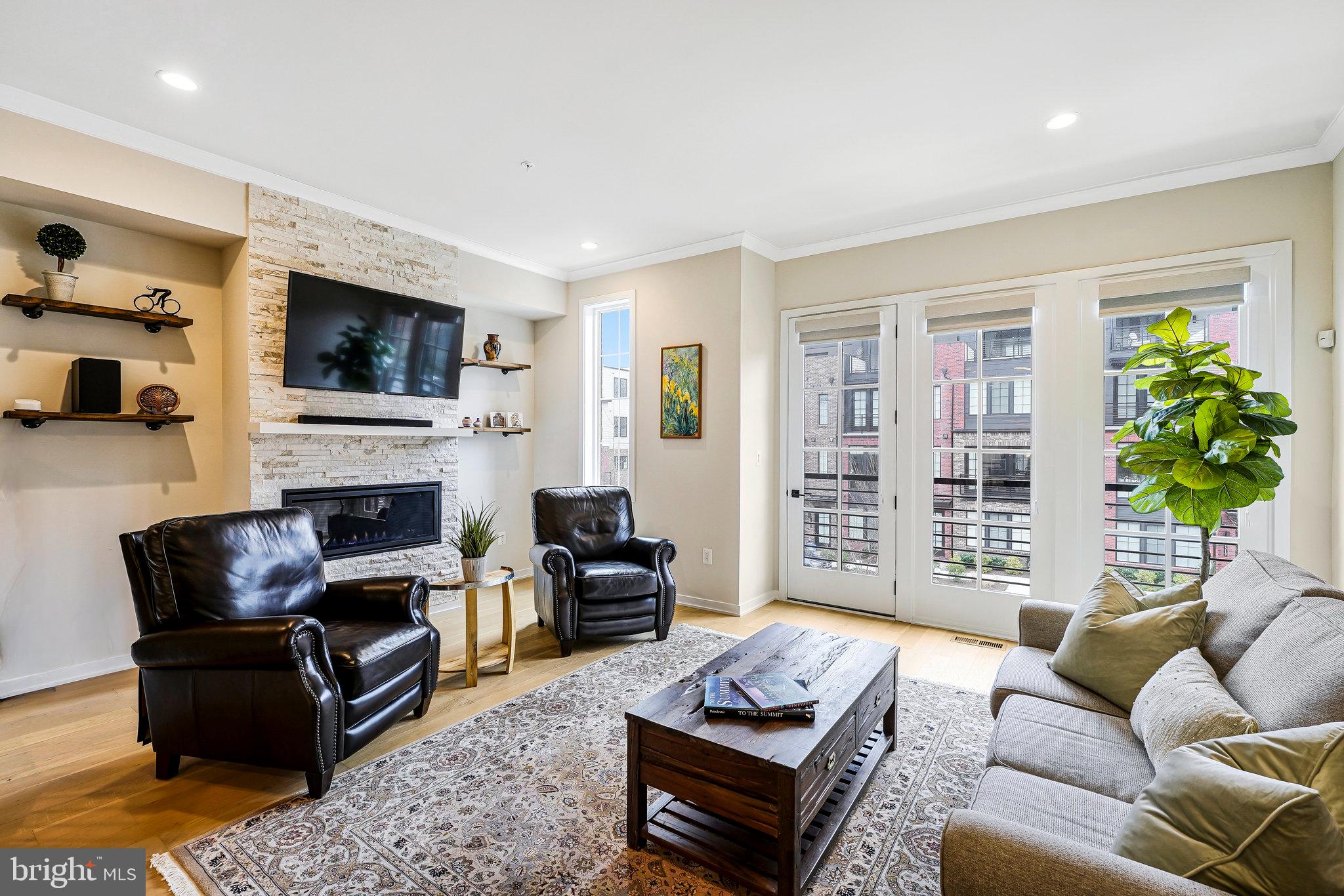 11716 Paysons Way Reston, VA 20191 - Photo 14 of 34 a living room with furniture a flat screen tv and a fireplace