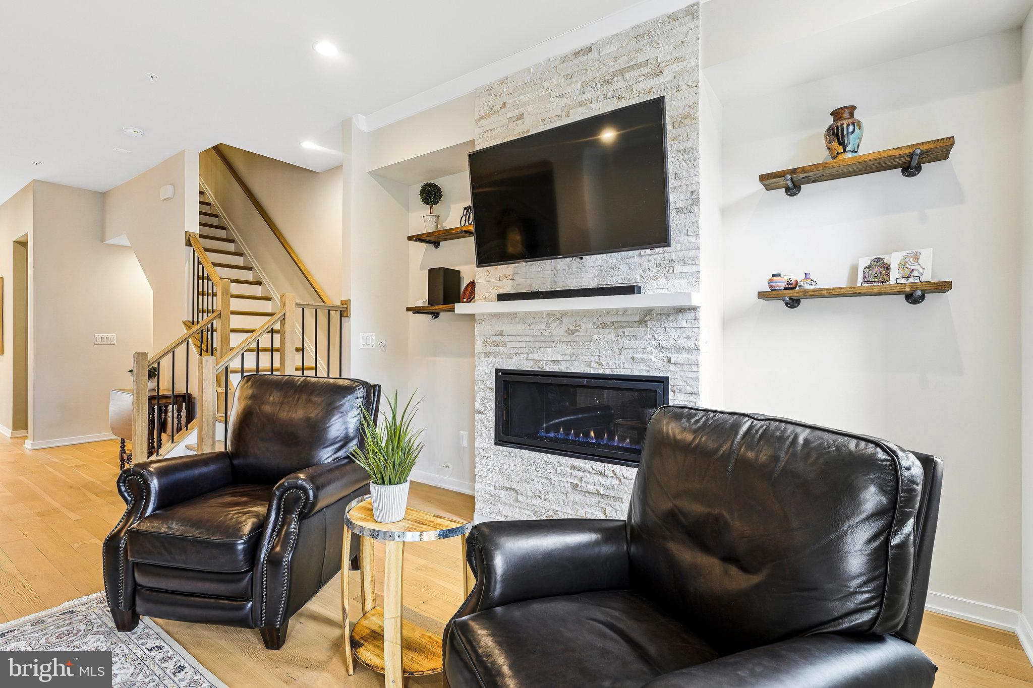 11716 Paysons Way Reston, VA 20191 - Photo 15 of 34 a living room with furniture a flat screen tv and a fireplace