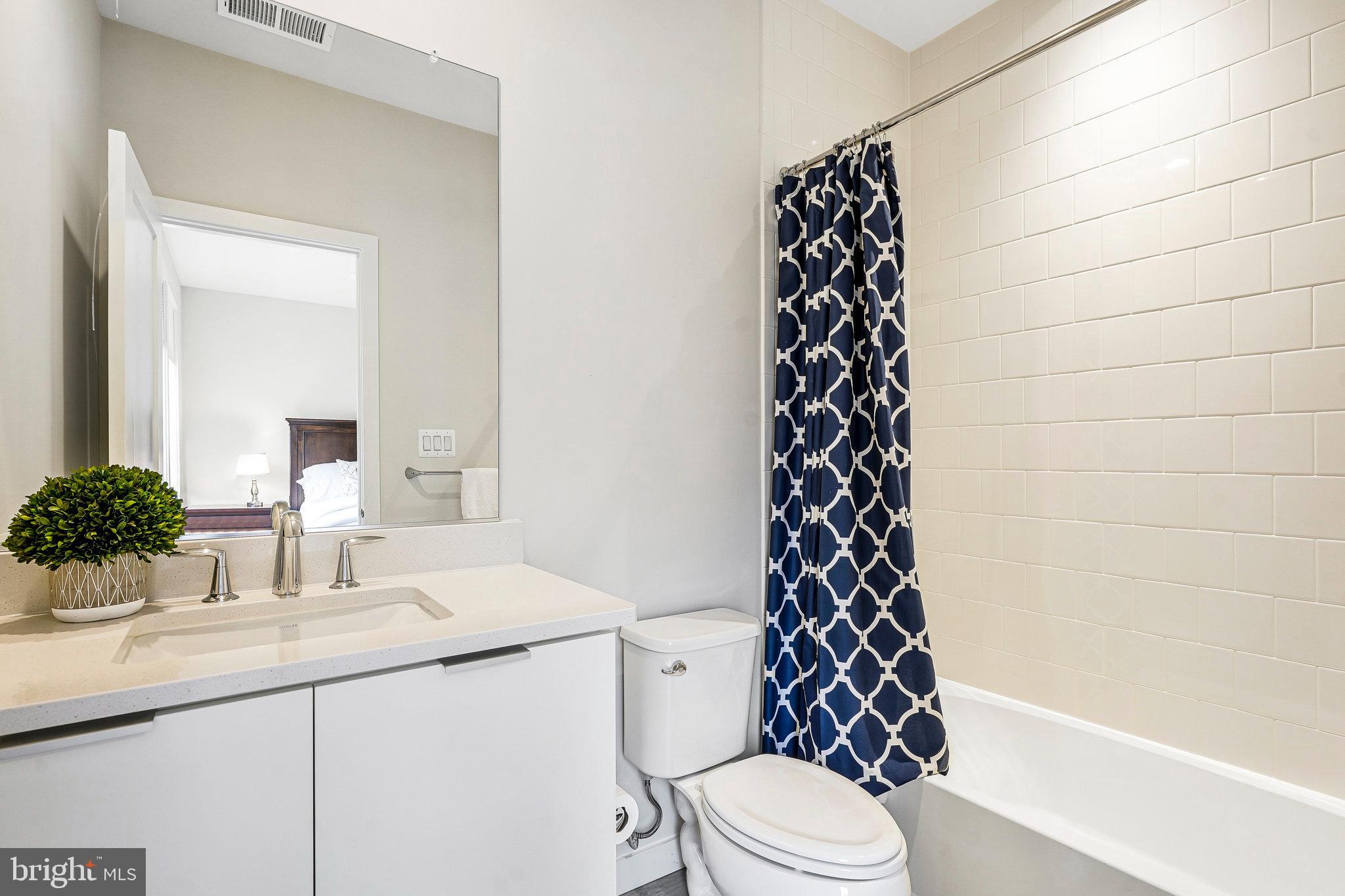 11716 Paysons Way Reston, VA 20191 - Photo 21 of 34 a bathroom with a sink a toilet and a mirror