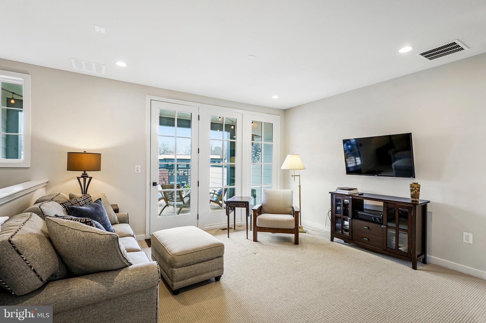 11716 Paysons Way Reston, VA 20191 - Photo 26 of 34 a living room with furniture and a flat screen tv