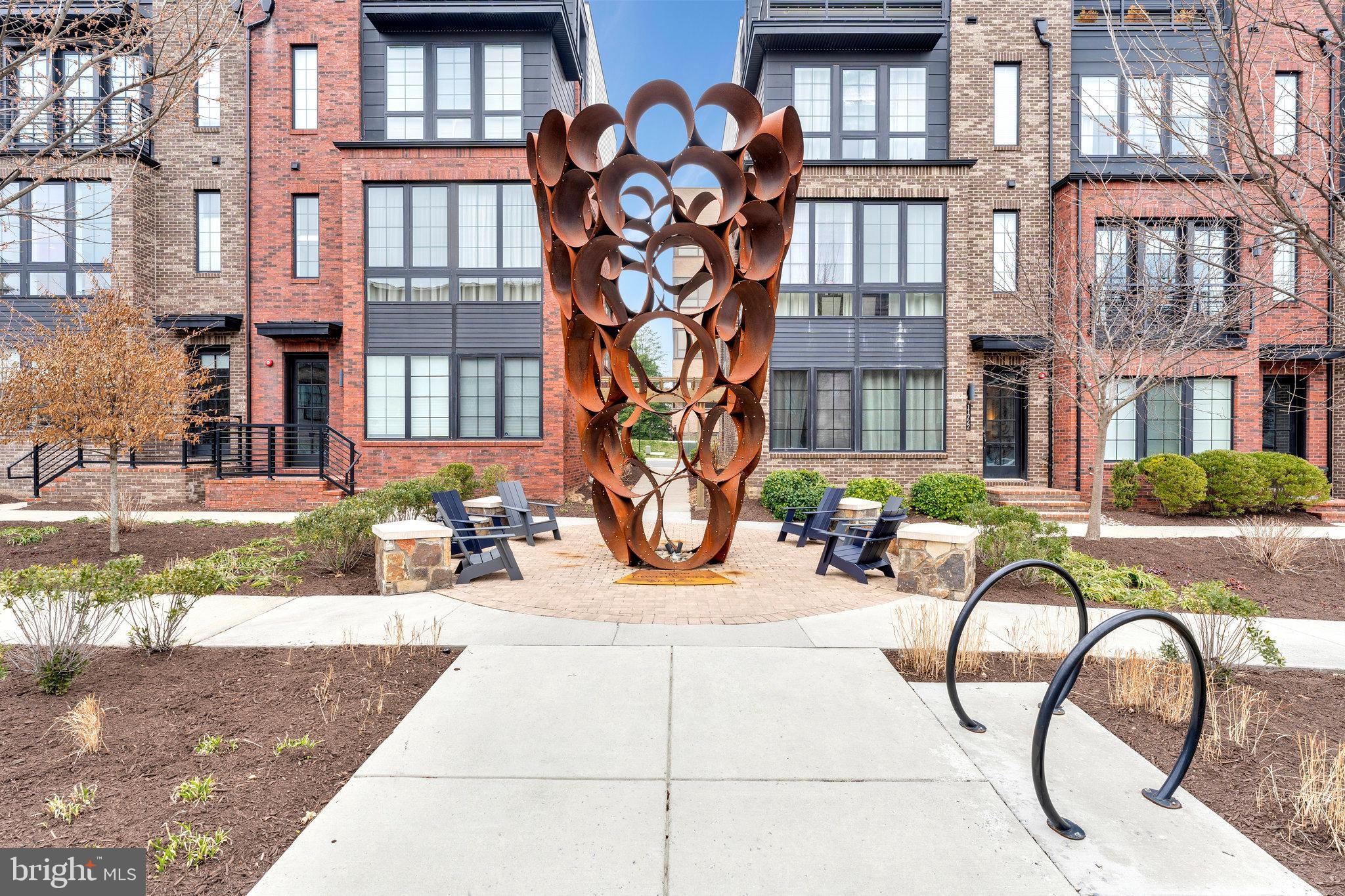 11716 Paysons Way Reston, VA 20191 - Photo 34 of 34 a view of a brick building with a bench in front of a building