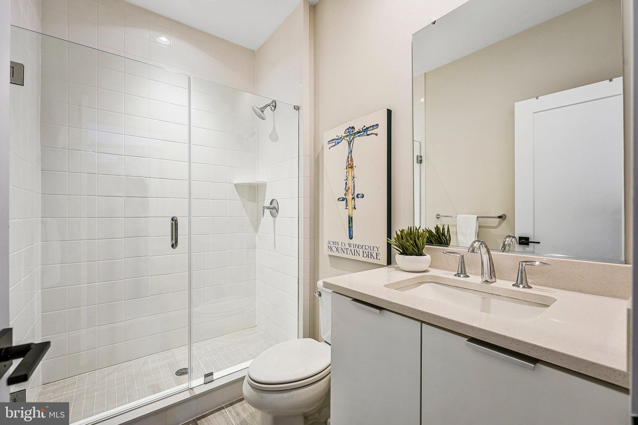 11716 Paysons Way Reston, VA 20191 - Photo 6 of 34 a bathroom with a shower sink vanity mirror and toilet