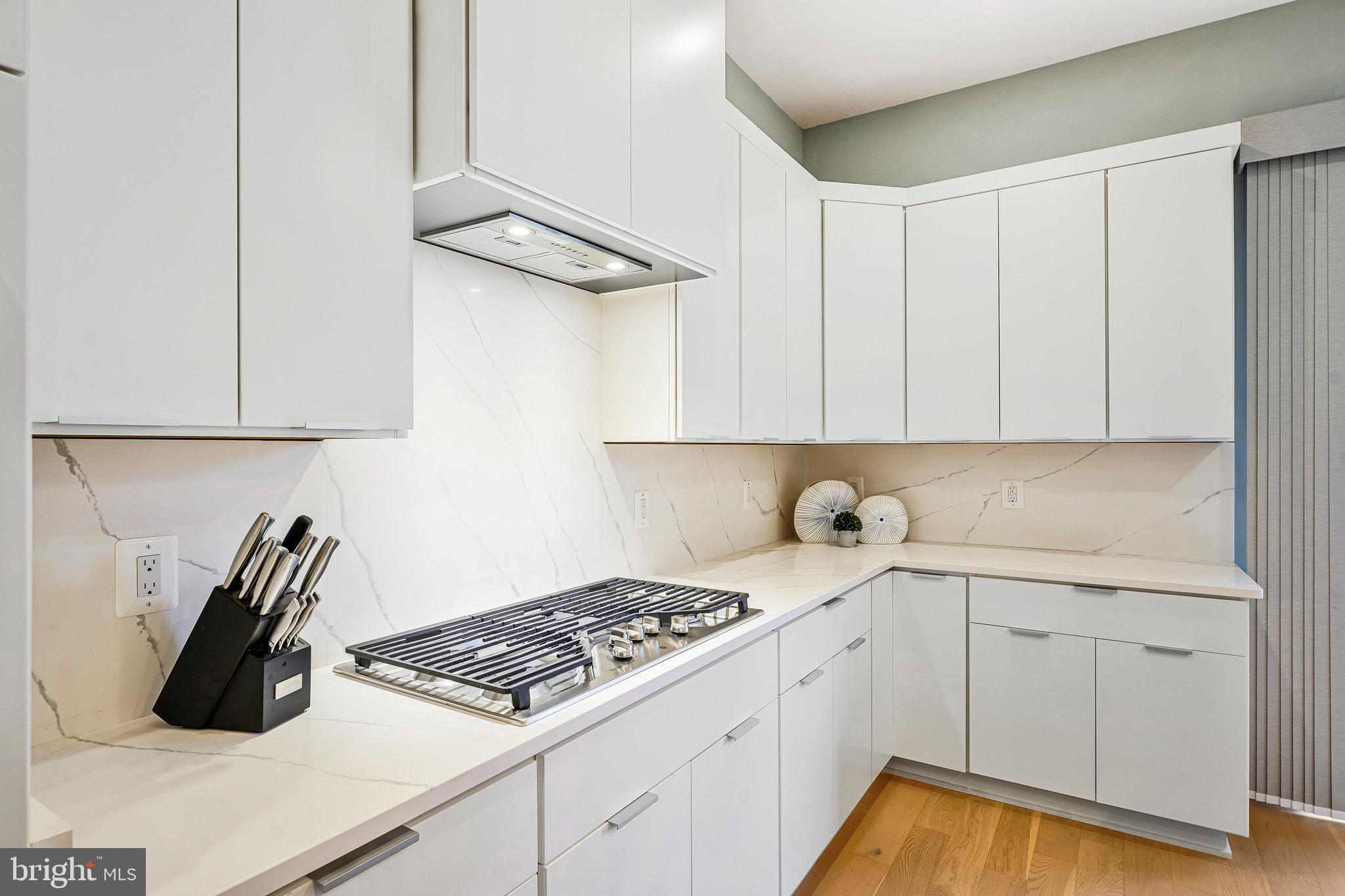 11716 Paysons Way Reston, VA 20191 - Photo 9 of 34 a kitchen with white cabinets and appliances