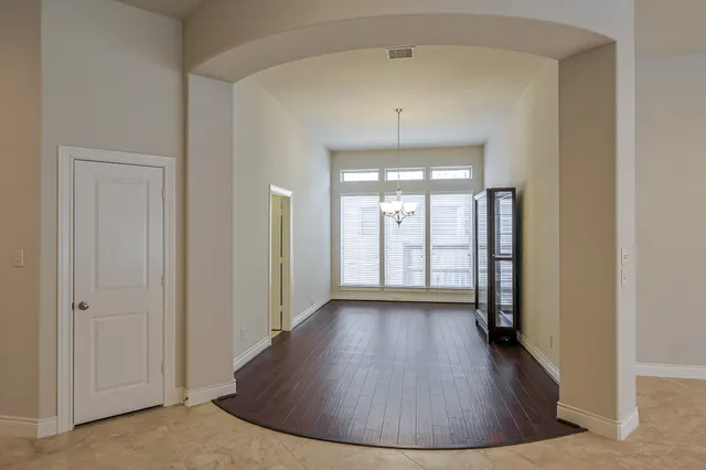 a view of an empty room with a ceiling fan