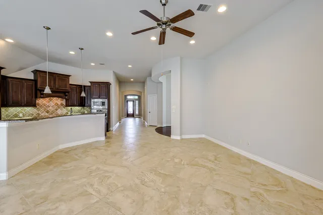 a view of kitchen with kitchen island stainless steel appliances refrigerator oven sink and cabinets