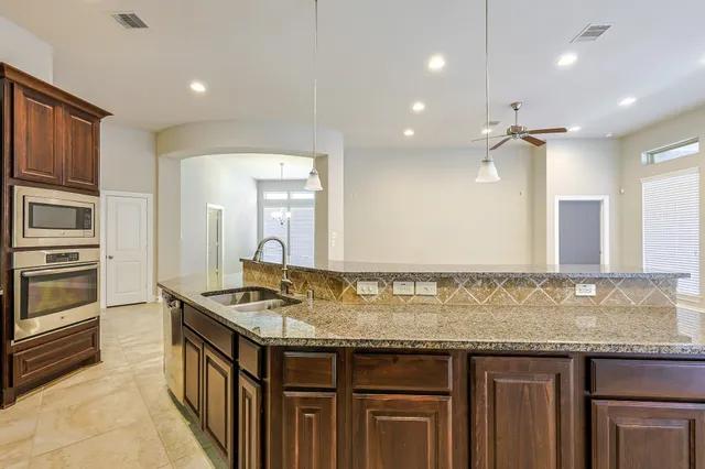 a bathroom with a granite countertop sink mirror and shower