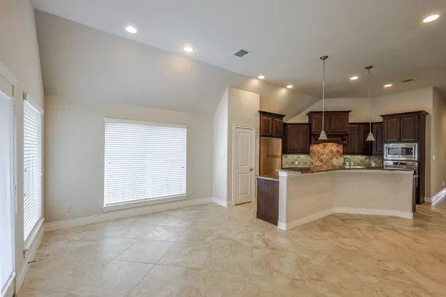 a bathroom with a granite countertop sink shower and a mirror