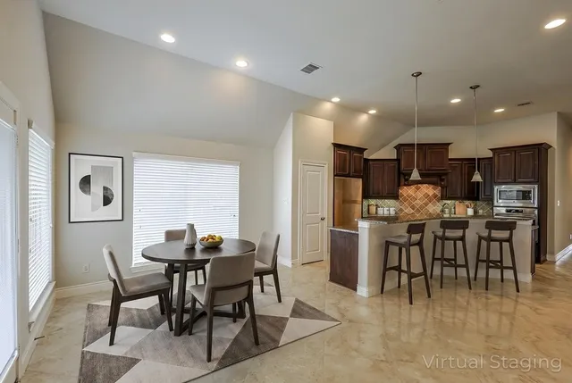 a bathroom with a granite countertop sink and mirror with bathtub