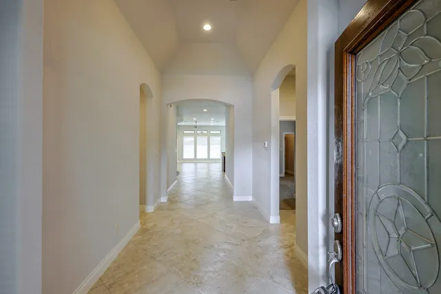a view of a hallway with windows and closet