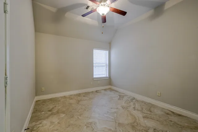 a bathroom with a granite countertop sink and cabinets