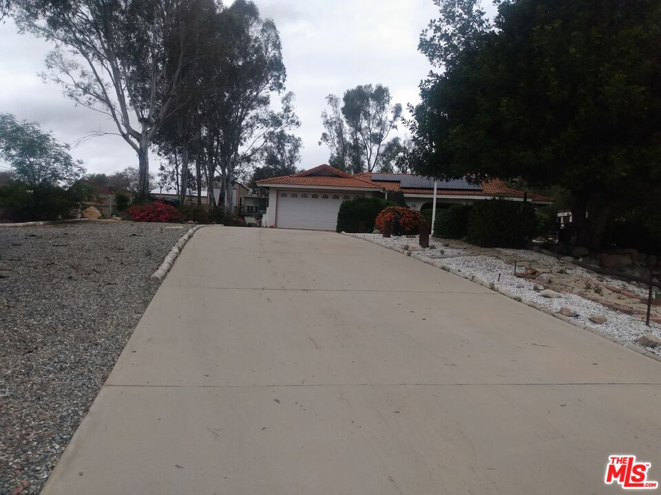 18420 Granite Avenue Riverside, CA 92508 - Photo 1 of 7 a house with trees in front of it
