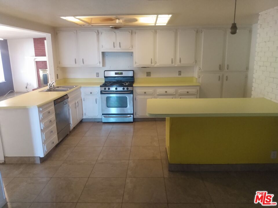 18420 Granite Avenue Riverside, CA 92508 - Photo 2 of 7 a kitchen with a cabinets and white appliances