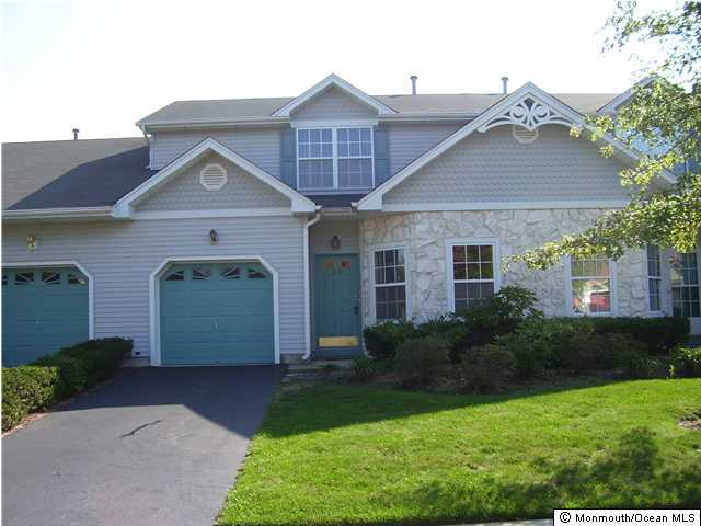 46 Riva Boulevard Brick, NJ 08723 - Photo 1 of 3 a front view of a house with a yard and garage