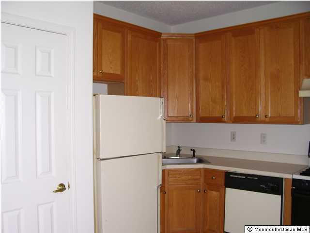 46 Riva Boulevard Brick, NJ 08723 - Photo 3 of 3 a kitchen with a refrigerator and a sink
