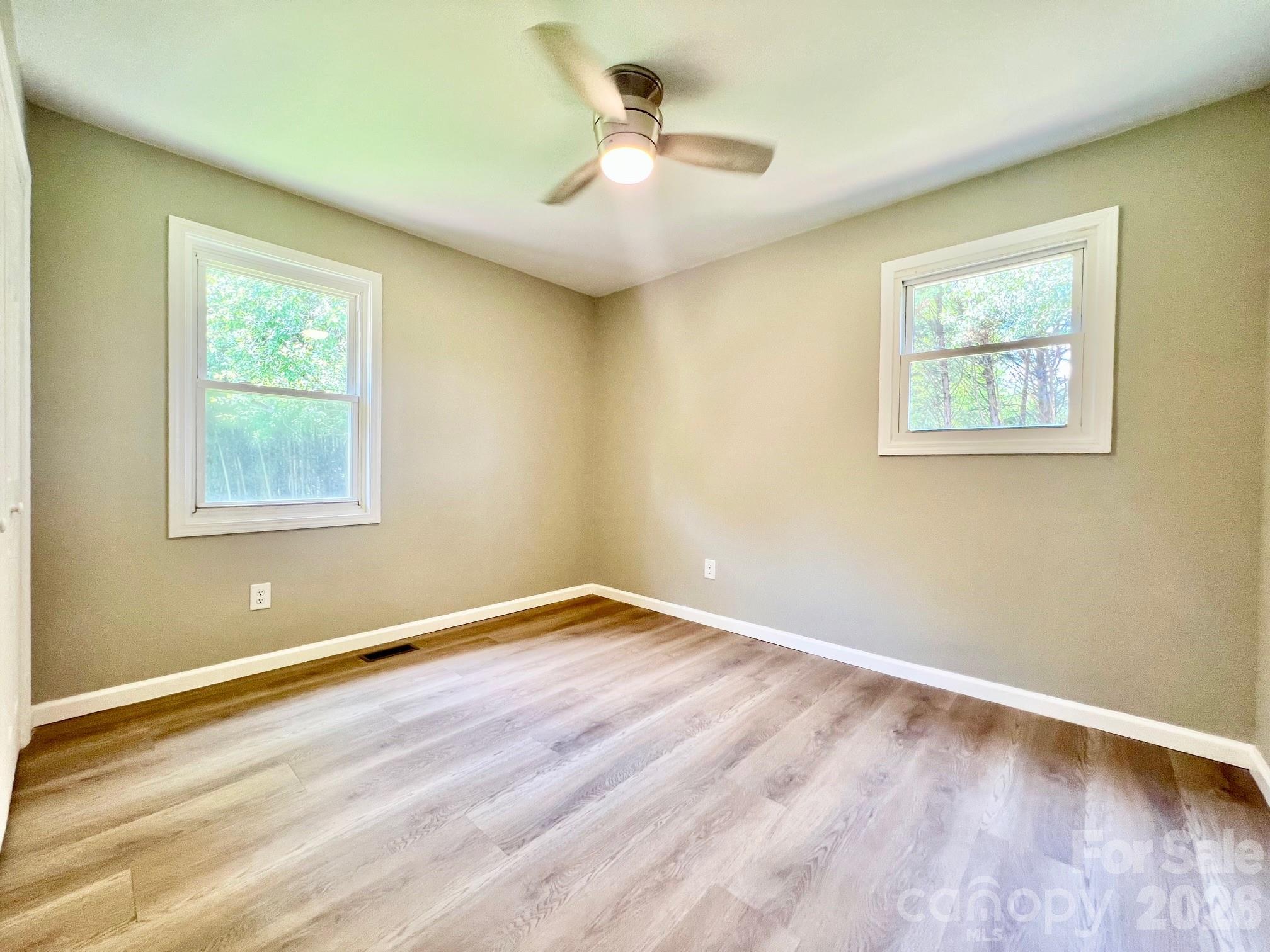 4506 Rink Dam Road Taylorsville, NC 28681 - Photo 12 of 20 a view of empty room with wooden floor and fan