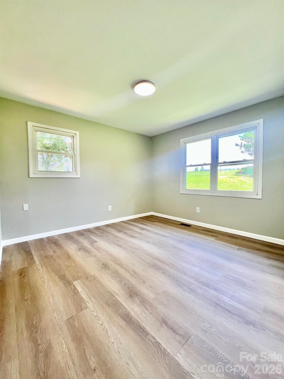 4506 Rink Dam Road Taylorsville, NC 28681 - Photo 13 of 20 an empty room with wooden floor and windows