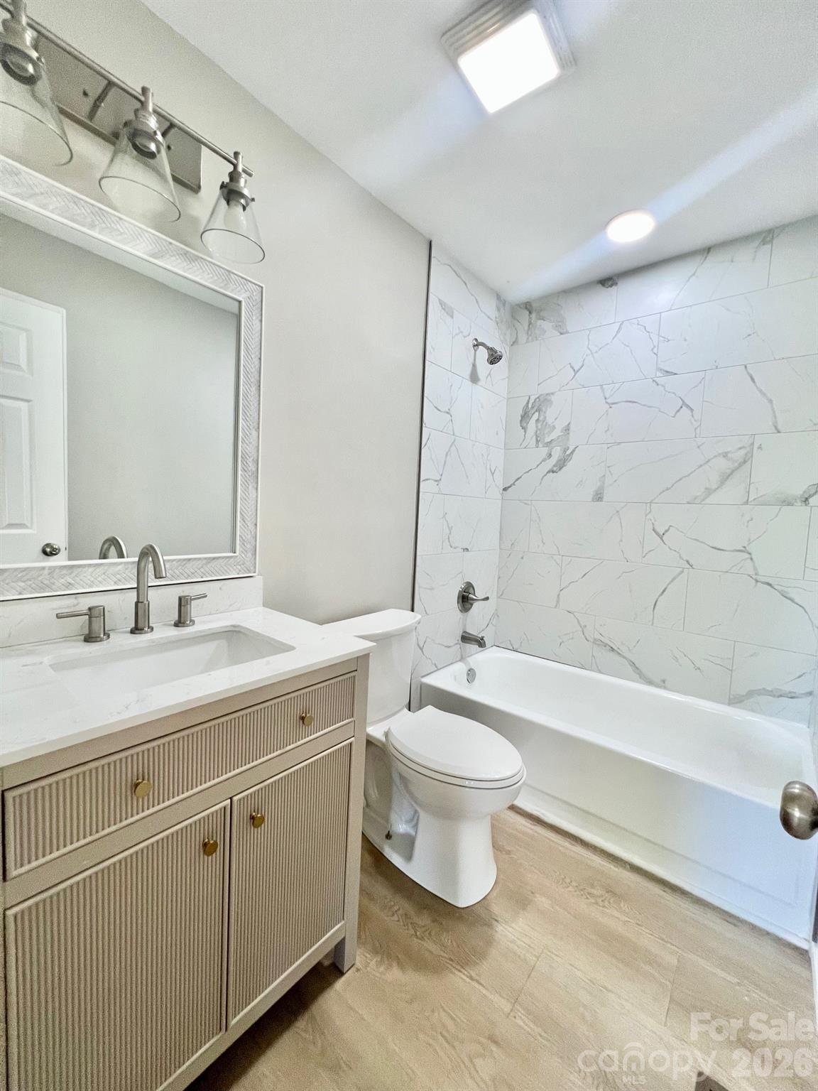 4506 Rink Dam Road Taylorsville, NC 28681 - Photo 14 of 20 a bathroom with a double vanity sink a toilet a mirror and bathtub