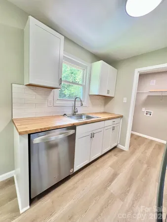 a kitchen with stainless steel appliances a sink stove and cabinets