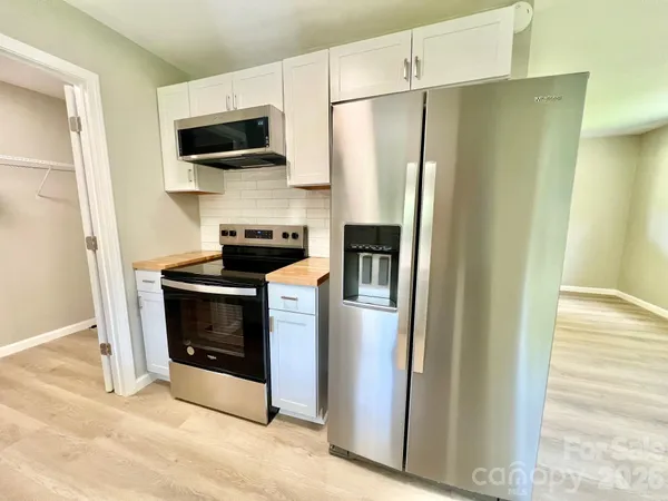 a kitchen with stainless steel appliances a refrigerator and a stove top oven