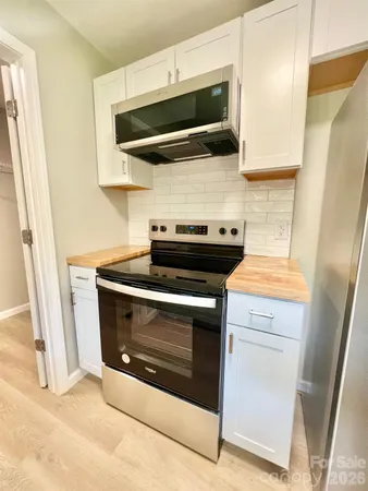 a stove top oven sitting inside of a kitchen