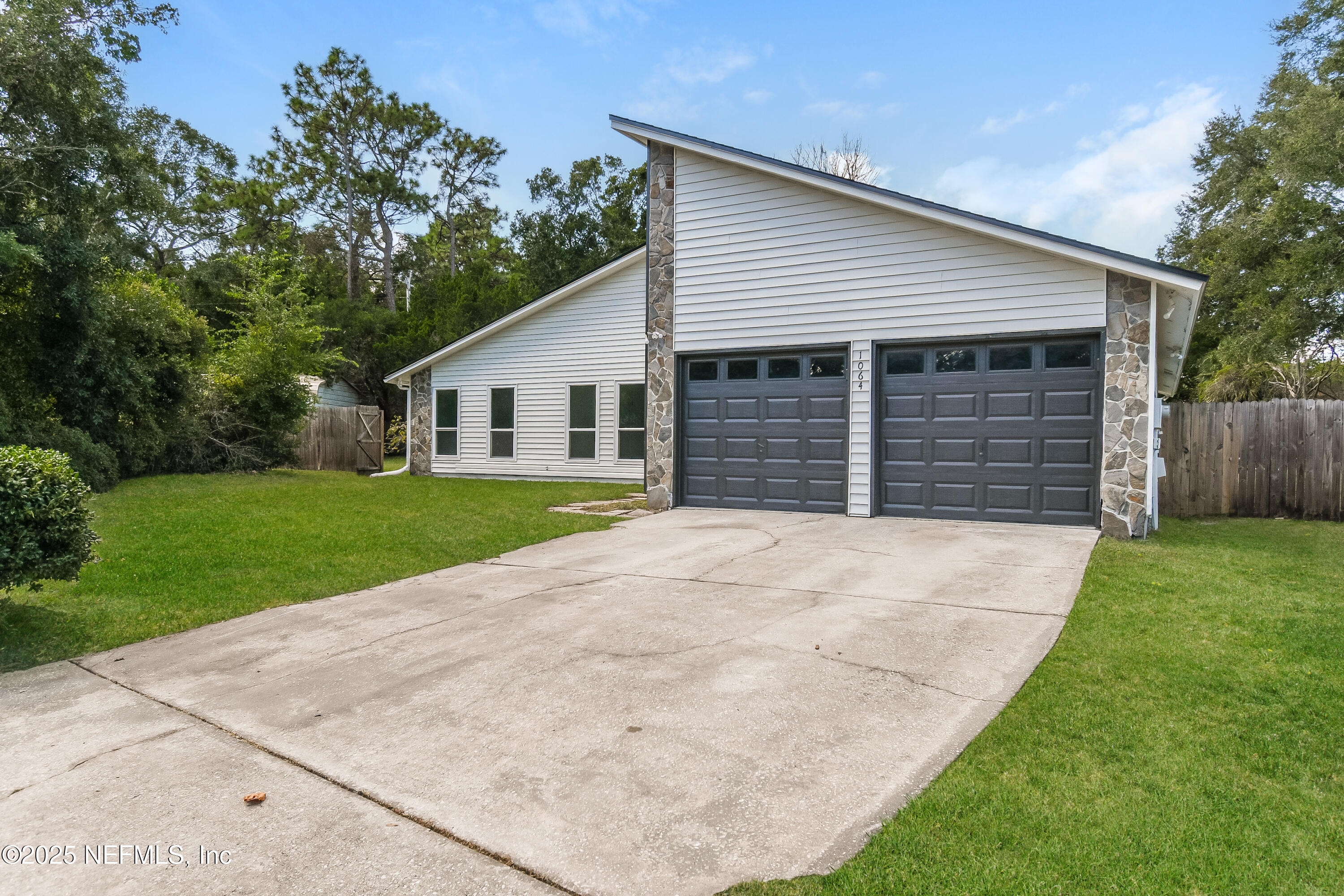 1064 Rene Court Orange Park, FL 32065 - Photo 1 of 20 a front view of a house with a yard