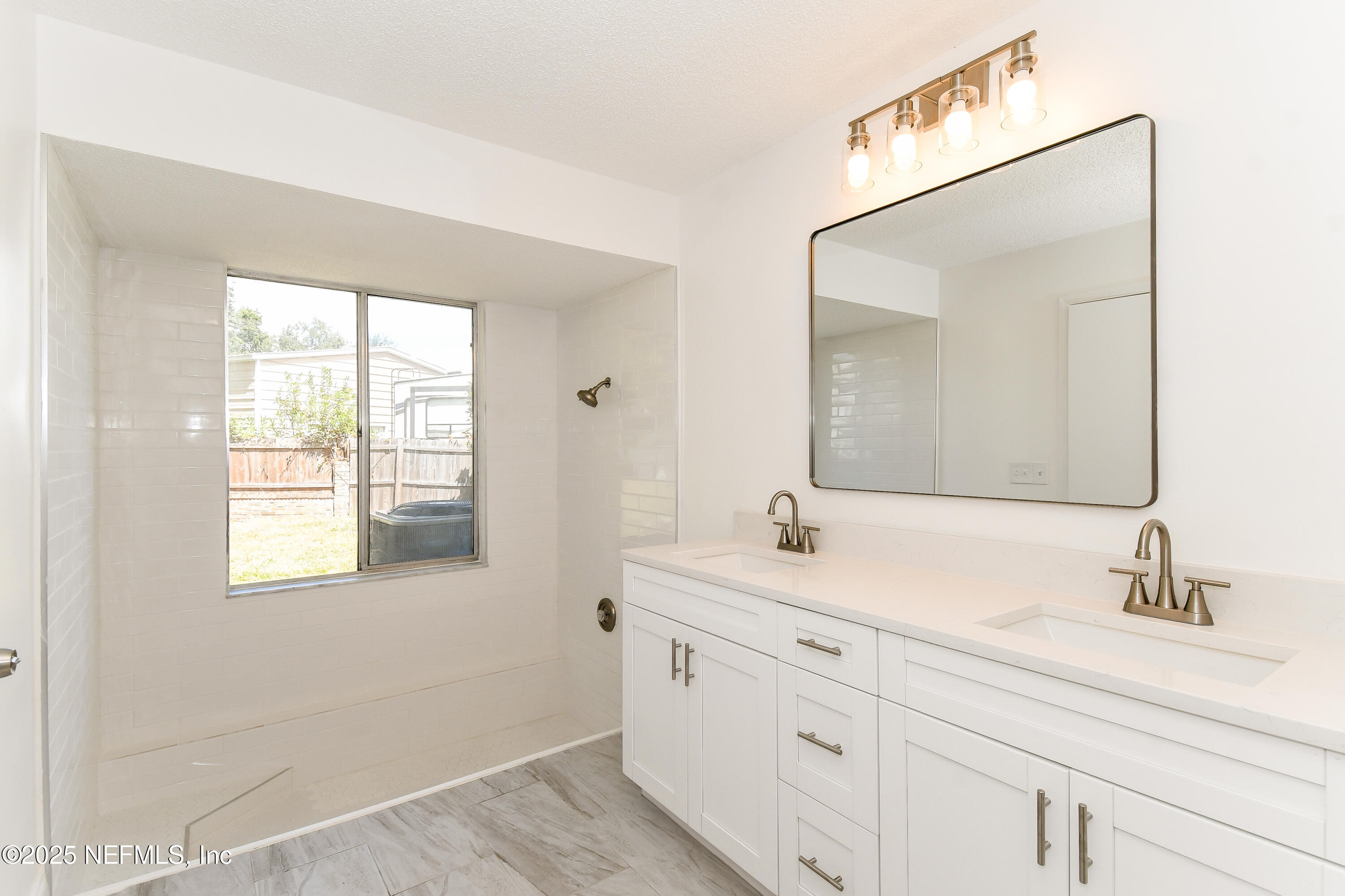 1064 Rene Court Orange Park, FL 32065 - Photo 12 of 20 a bathroom with a sink and a mirror