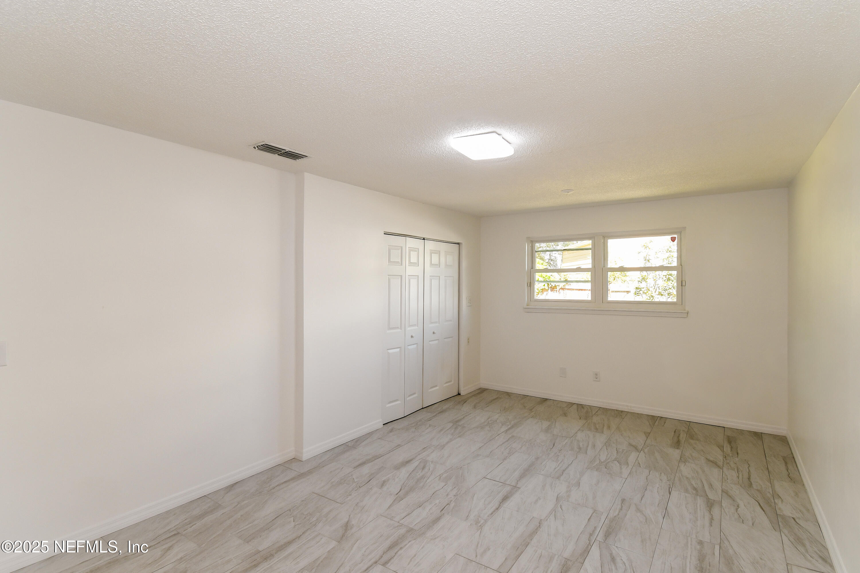 1064 Rene Court Orange Park, FL 32065 - Photo 13 of 20 a view of an empty room with wooden floor and a window