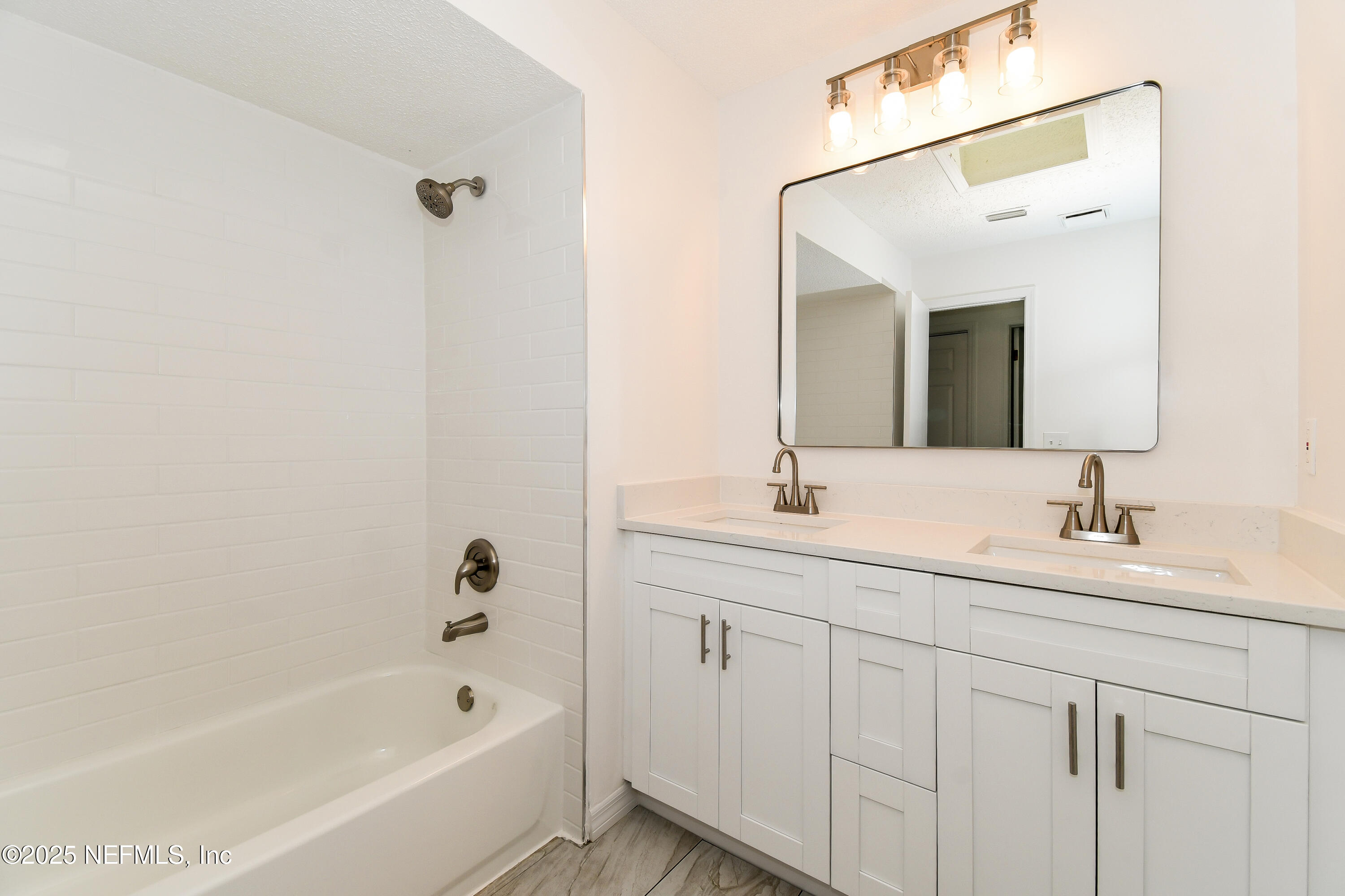 1064 Rene Court Orange Park, FL 32065 - Photo 17 of 20 a bathroom with a tub sink and mirror