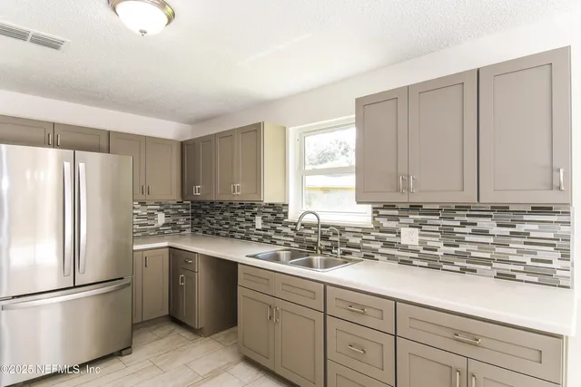a kitchen with stainless steel appliances granite countertop a stove a refrigerator and a refrigerator