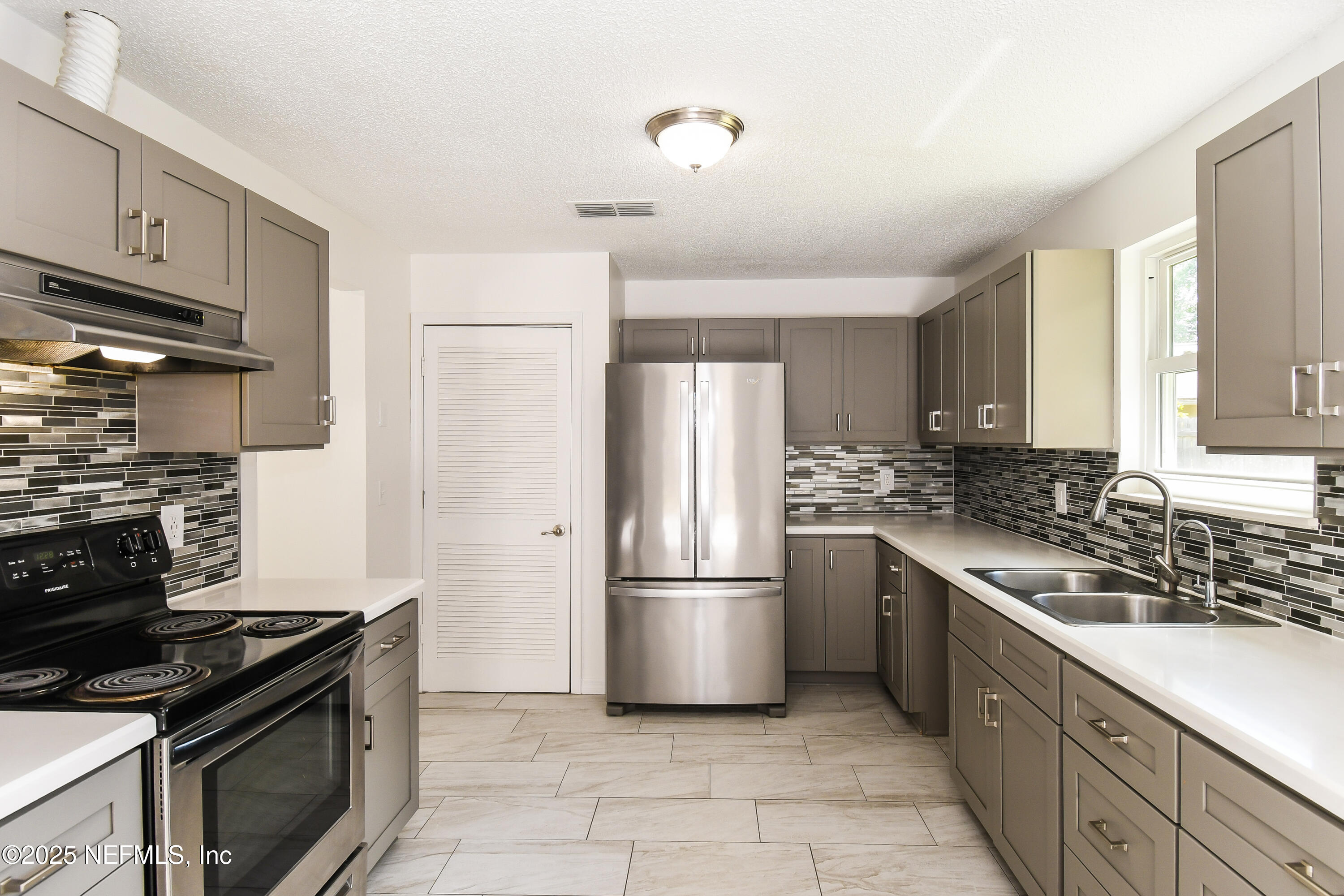 1064 Rene Court Orange Park, FL 32065 - Photo 9 of 20 a kitchen with stainless steel appliances granite countertop a stove a refrigerator and a refrigerator