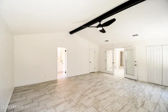 an empty room with windows and closet