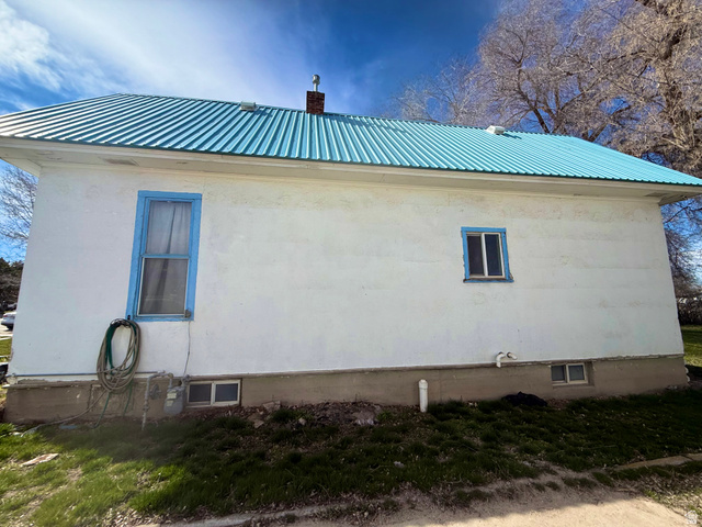 274 West Oneida Street Preston, ID 83263 - Photo 2 of 6 View of property exterior featuring a metal roof and a chimney