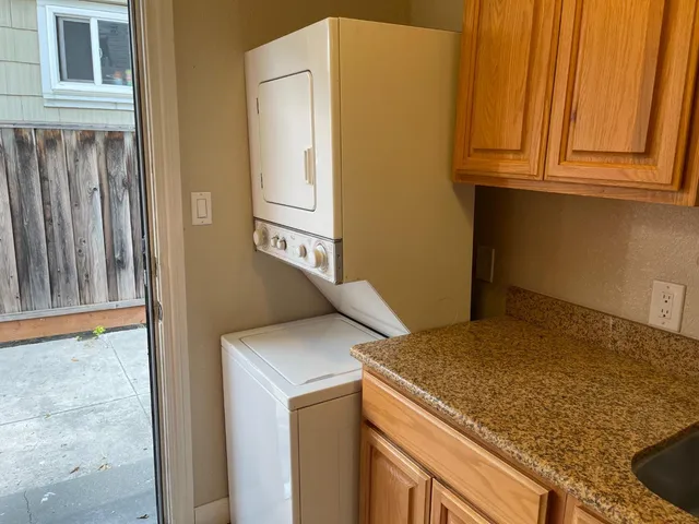 a kitchen with stainless steel appliances granite countertop a refrigerator and a stove