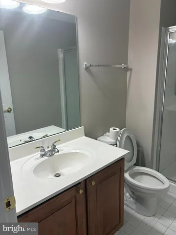 a bathroom with a sink a toilet and mirror