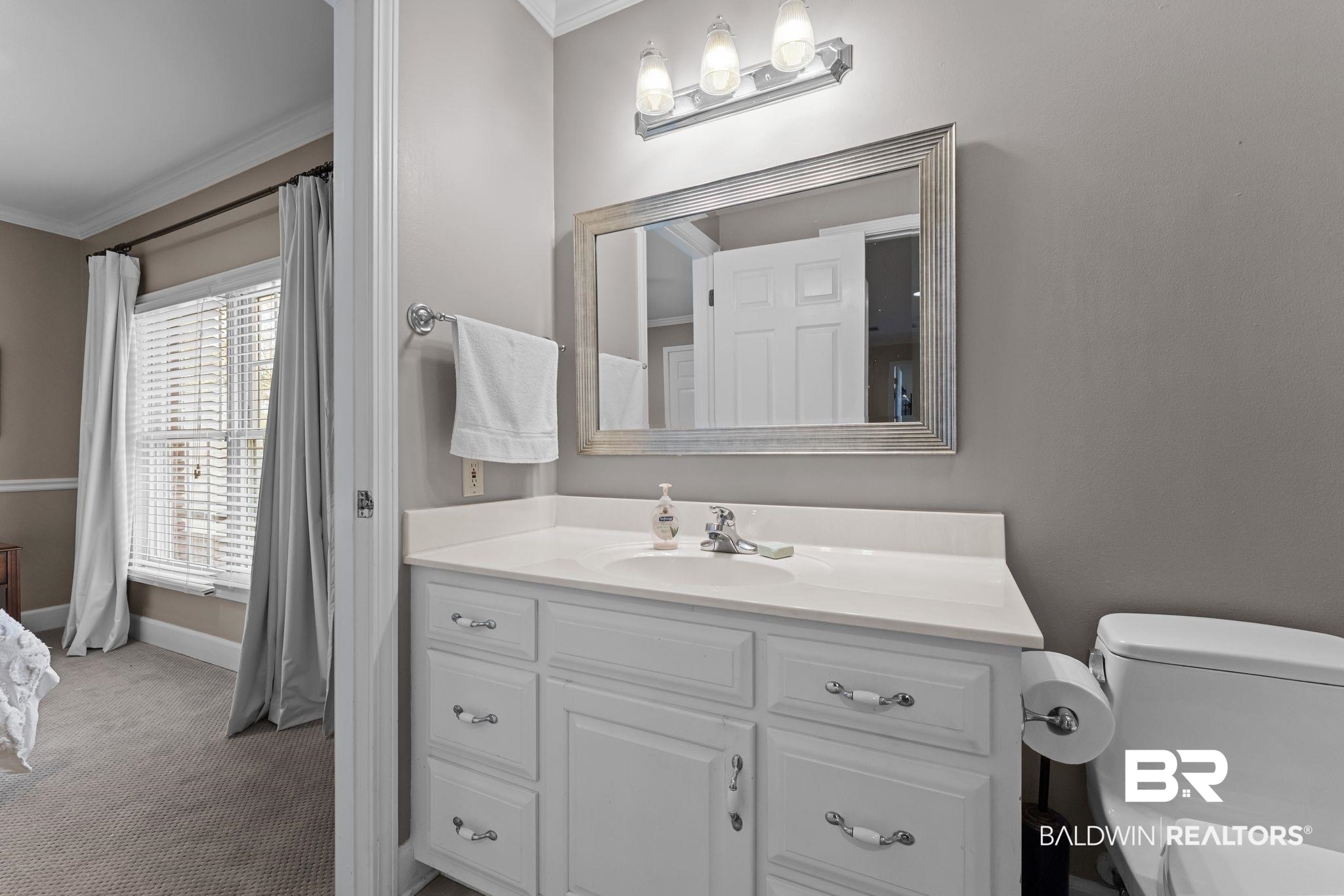 525 Norwood Road Monroeville, AL 36460 - Photo 36 of 55 Bathroom featuring vanity, crown molding, and carpet floors