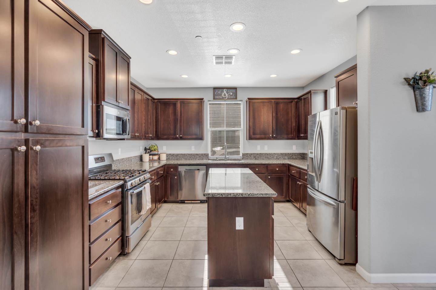 2284 Province Place Hughson, CA 95326 - Photo 18 of 53 a kitchen with stainless steel appliances granite countertop refrigerator a sink and a stove