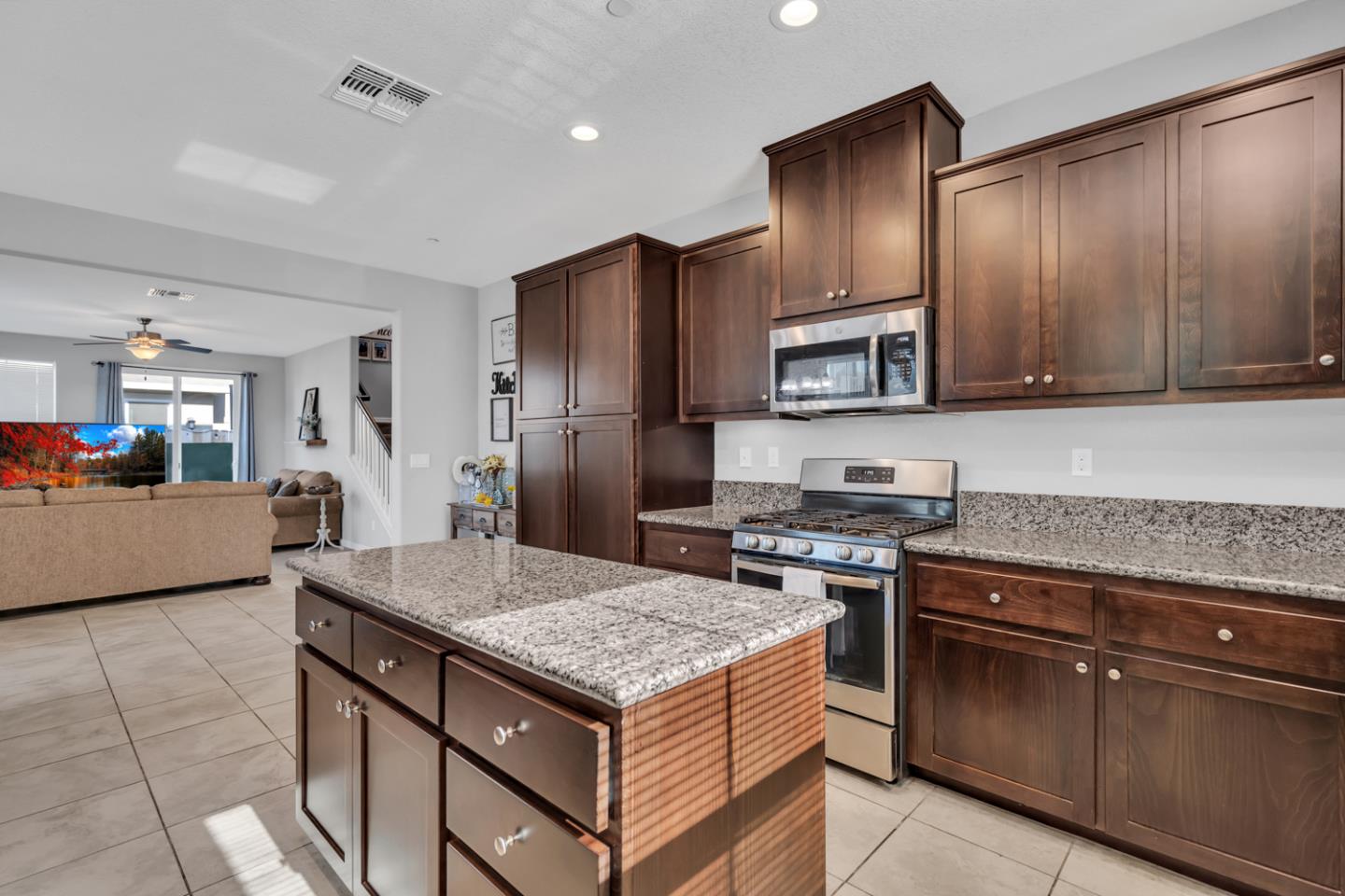 2284 Province Place Hughson, CA 95326 - Photo 20 of 53 a kitchen with kitchen island granite countertop wooden cabinets and stainless steel appliances