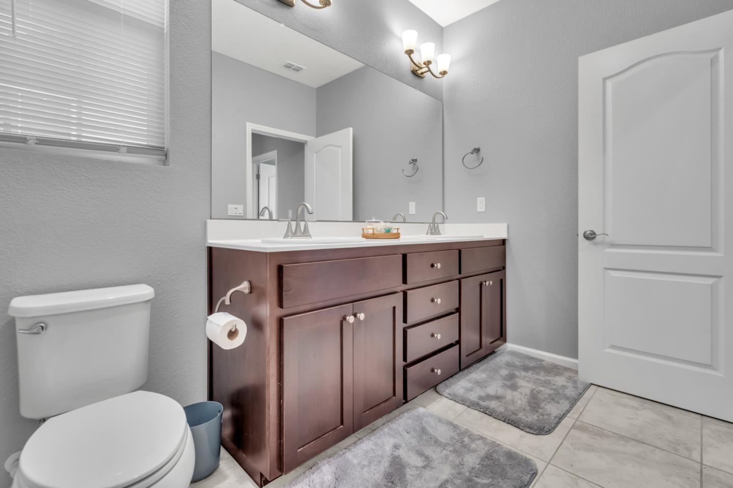 2284 Province Place Hughson, CA 95326 - Photo 33 of 53 a view of bathroom with a toilet sink and mirror