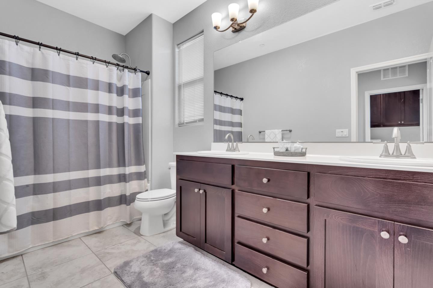 2284 Province Place Hughson, CA 95326 - Photo 34 of 53 a bathroom with a sink toilet a shower and a mirror