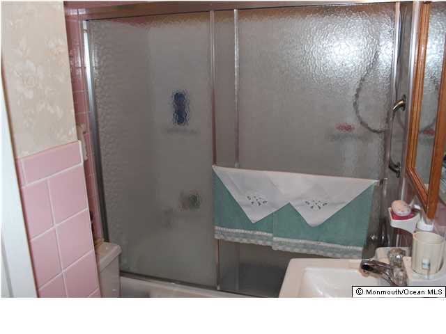 302 Church Road Brick, NJ 08723 - Photo 11 of 13 a bathroom with a sink and mirror