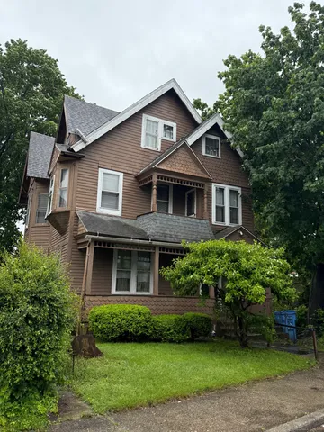 a front view of a house with a garden