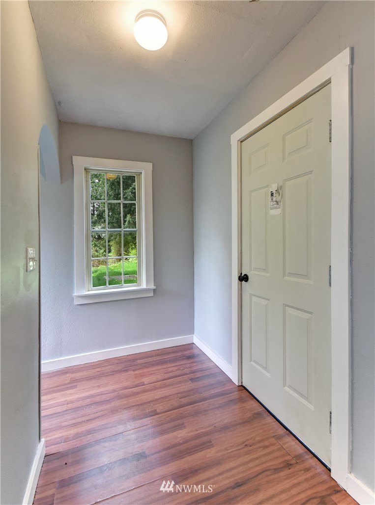 6930 Lower Ridge Road Everett, WA 98203 - Photo 9 of 15 a view of an empty room with wooden floor and a window