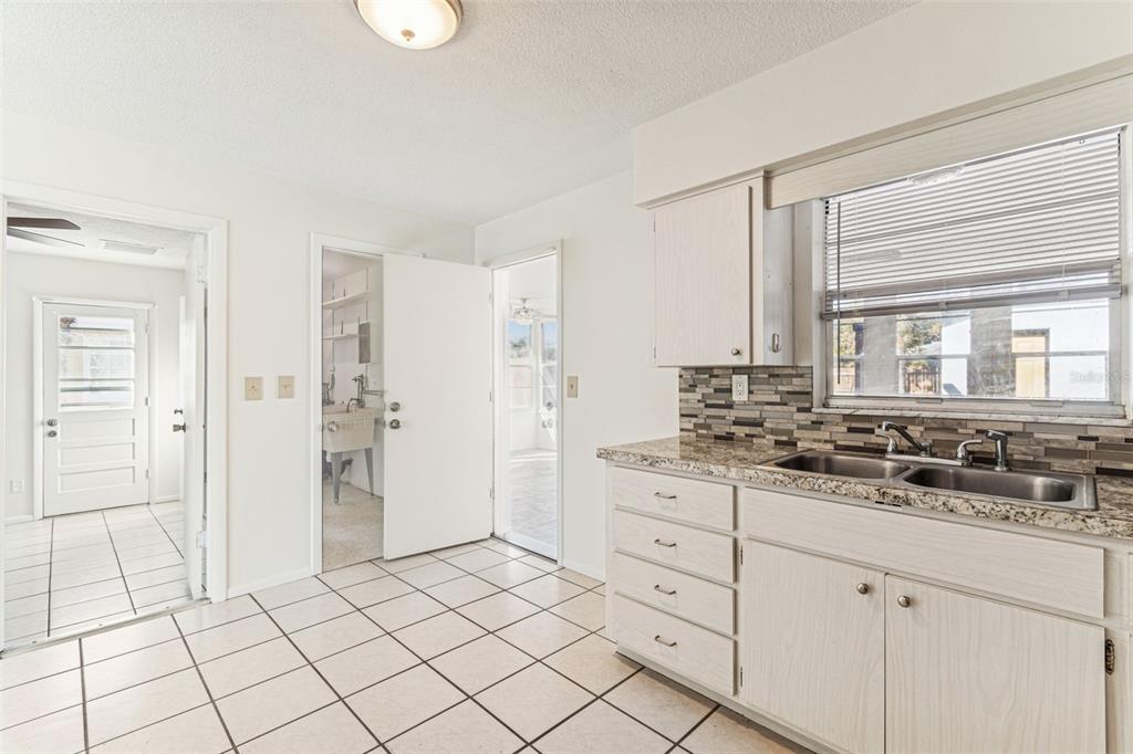 822 3rd Avenue Northwest Largo, FL 33770 - Photo 21 of 75 a spacious bathroom with a granite countertop sink and a mirror