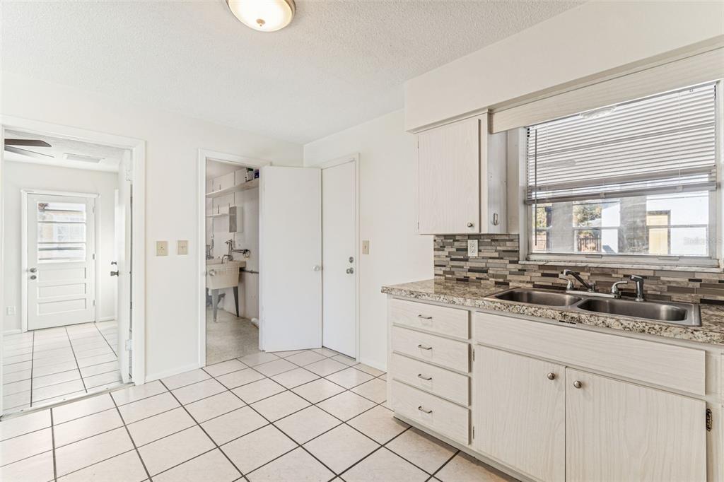 822 3rd Avenue Northwest Largo, FL 33770 - Photo 22 of 75 a spacious bathroom with a granite countertop sink and a mirror